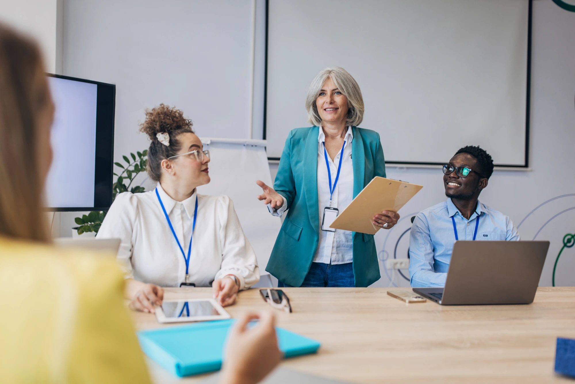 Team meeting with a presenter speaking confidently.